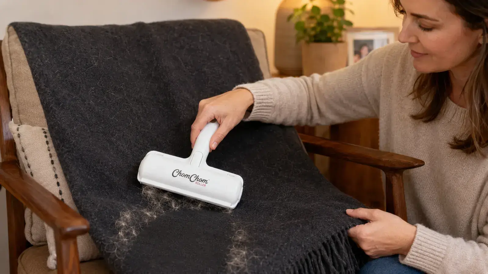 ChomChom Roller being emptied of collected dog and cat hair into a trash can